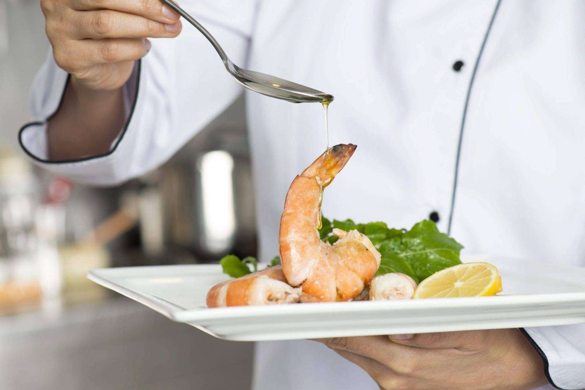Chef with Shrimp Chef completing shrimp plate.